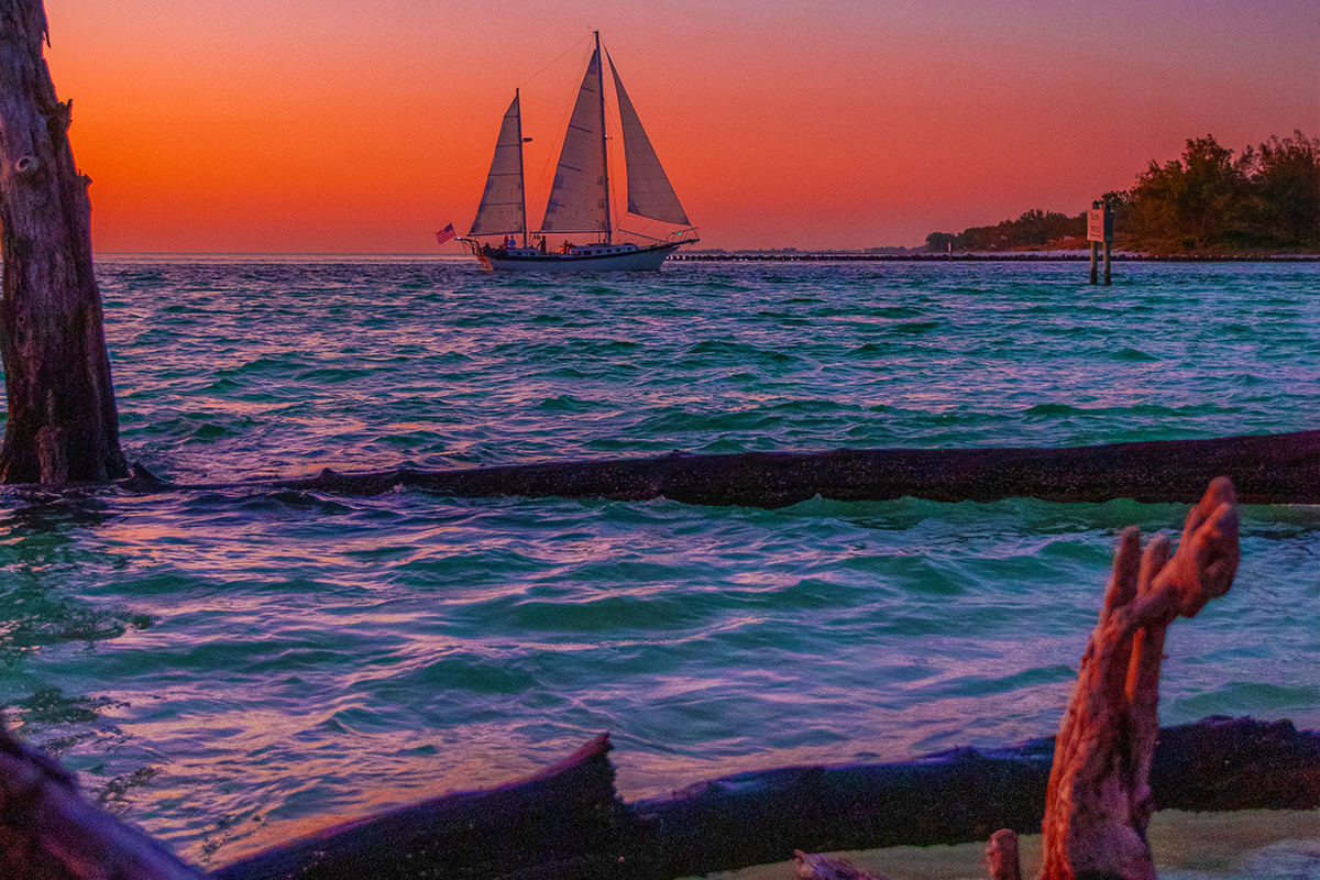 Sailboat at sunset near Beer Can Island and Longboat Pass