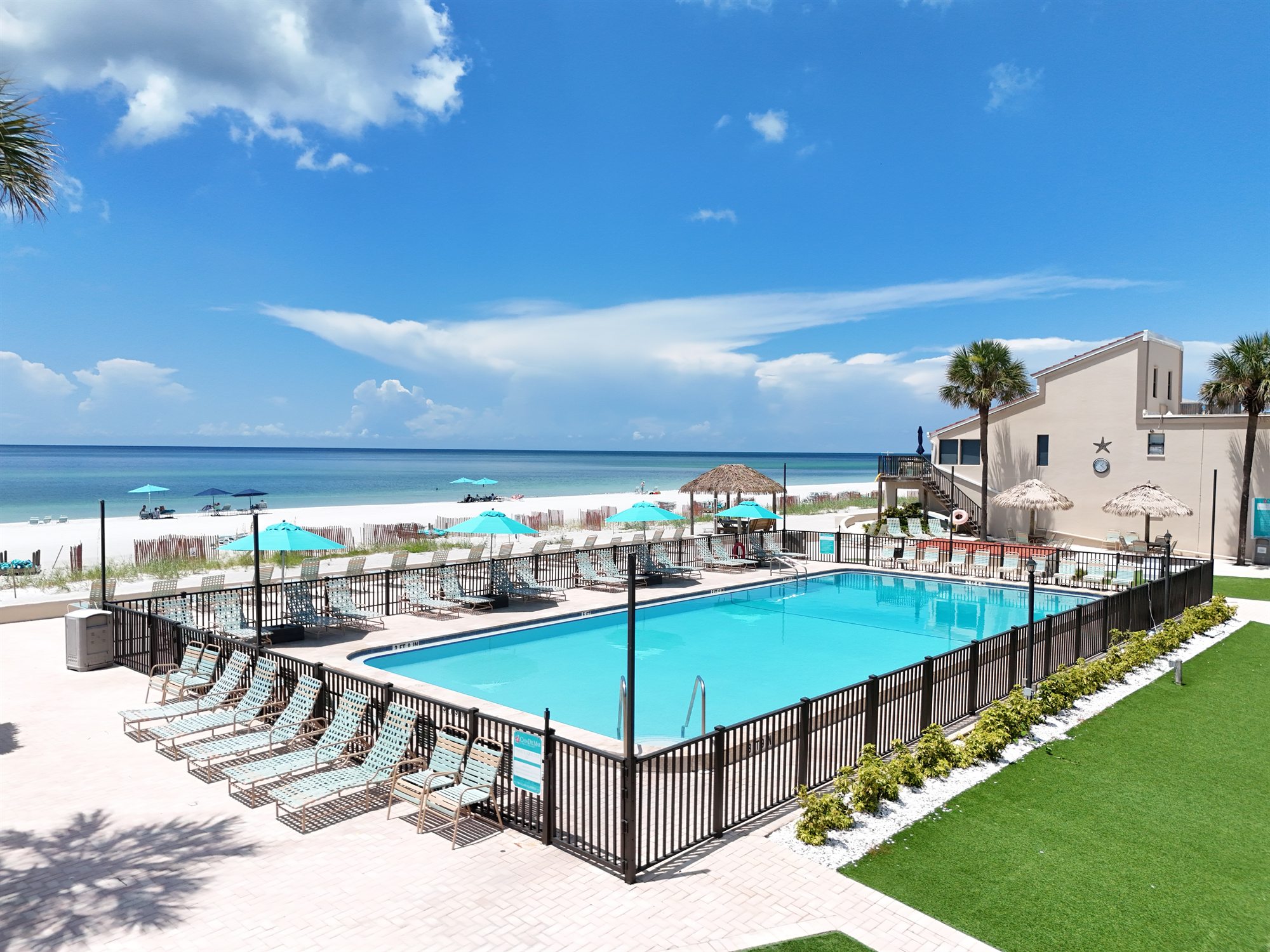 Casa Del Mar heated pool with lounge seating beside the Longboat Key beach