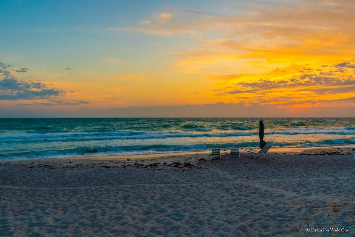 Colorful sunset reflected on the Gulf beside Casa Del Mar