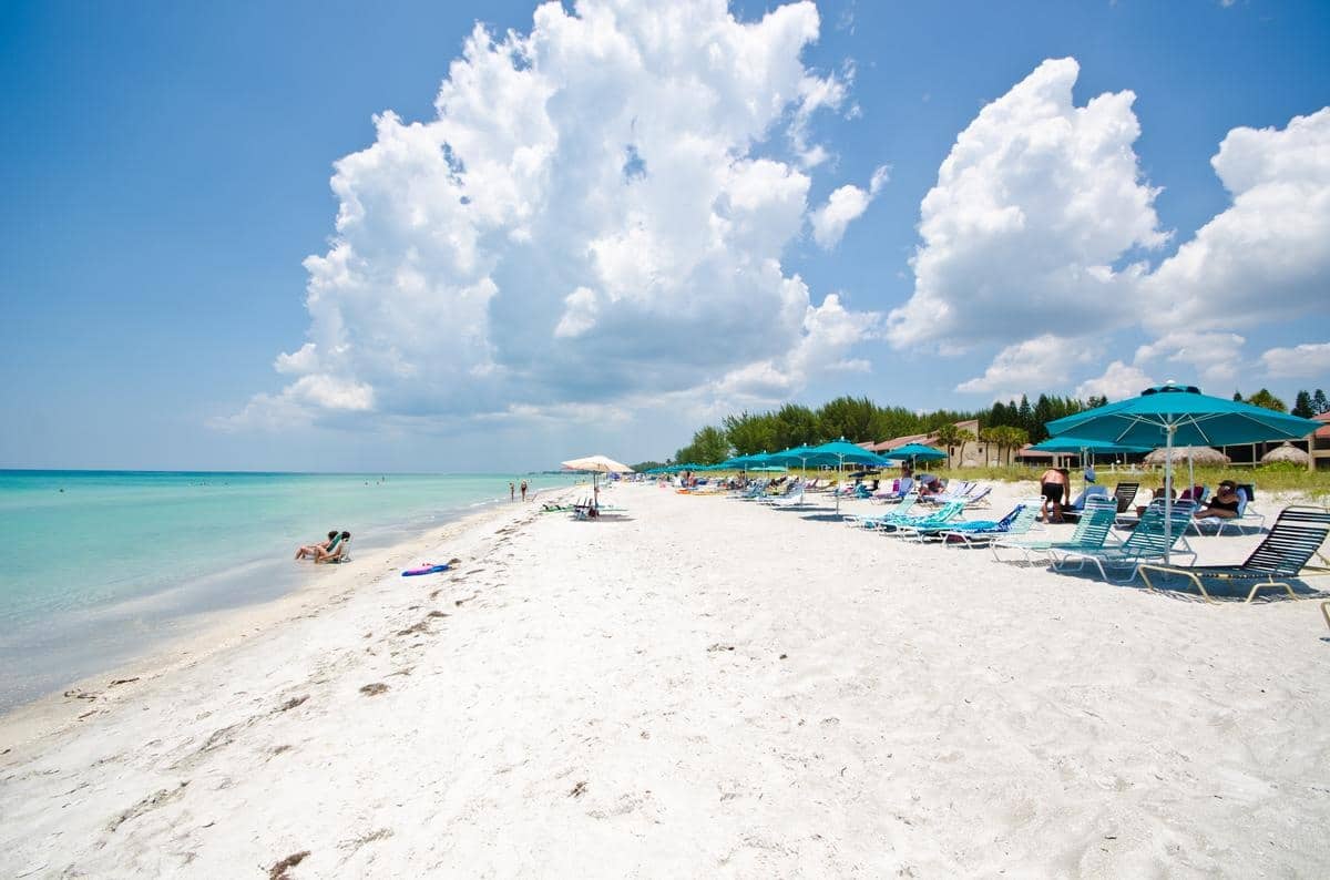 Wide view of the white-sand Longboat Key beach beside Casa Del Mar