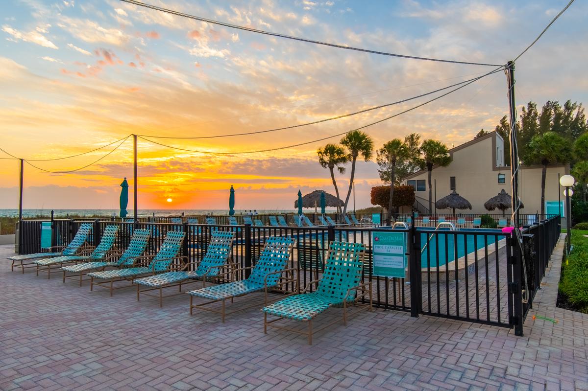 Lounge chairs around the Casa Del Mar pool deck at sunset