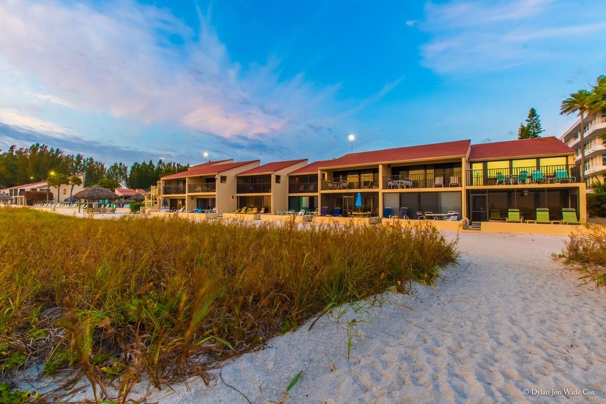 Casa Del Mar resort buildings seen from the beach at sunset